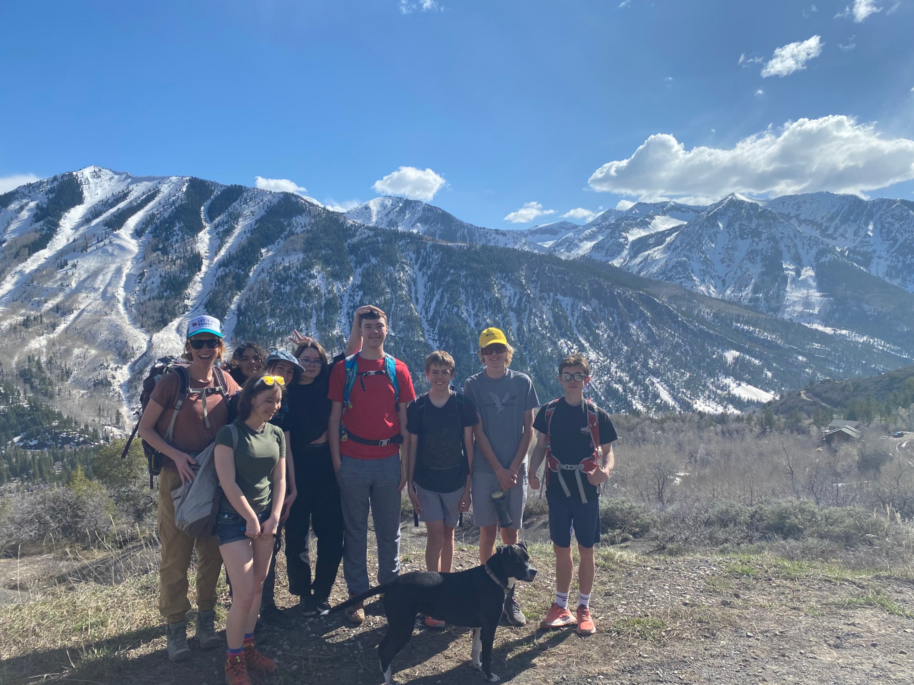 Outdoor Leadership students taking a photo outside with mountains in the background